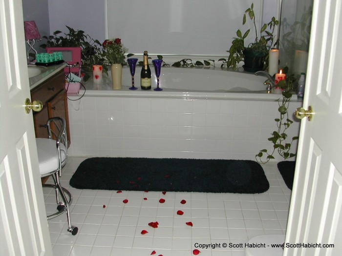 And into the bathroom with a drawn bath, candles, and of course, Champagne.