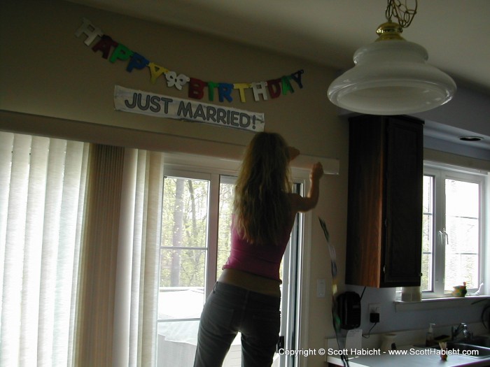 Kelli hangs the banners for the multi-purpose party....