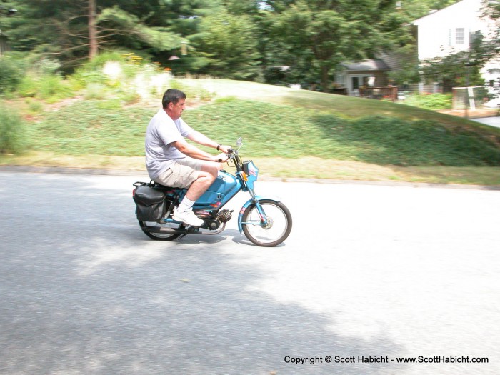 Mike making sure the mopeds work before selling them.