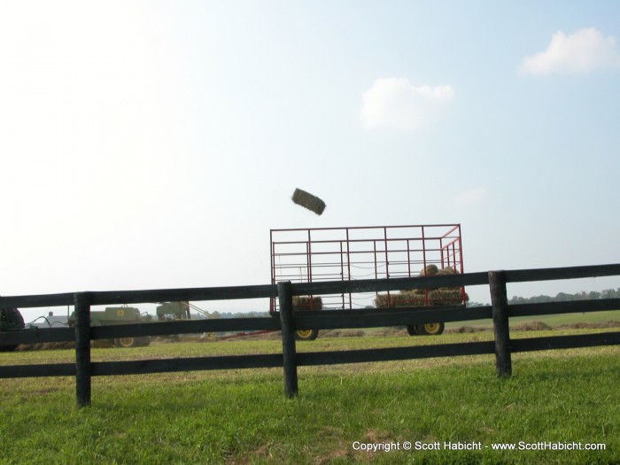 Bales of hay were falling from the sky, good thing this farmer was there to catch them.