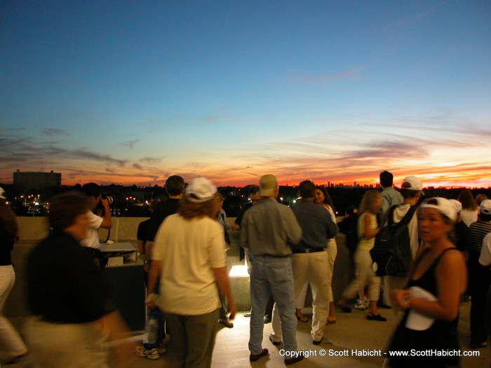 This crowd of people was taking pictures of the sunset before it was gone.