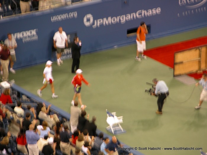 Justine Henin-Hardenne and Kim Clijsters (both Belgian) enter the court.