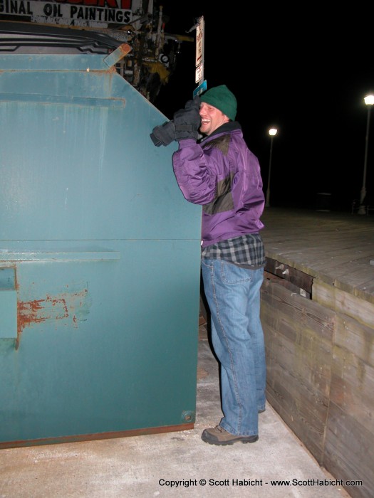 After all that exercise, he leans on a dumpster to get some rest.