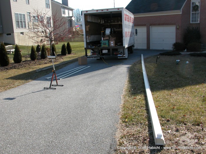 A big spool of sheet metal just spits out 45 feet of gutter.