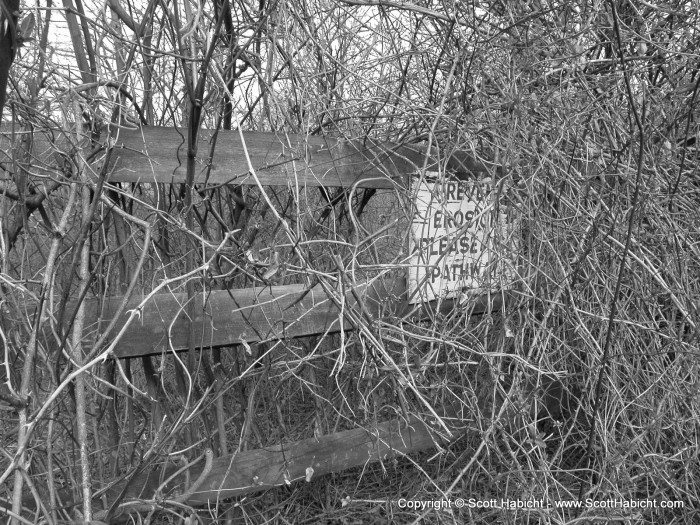 The sign says, "Prevent erosion, please use the pathway"