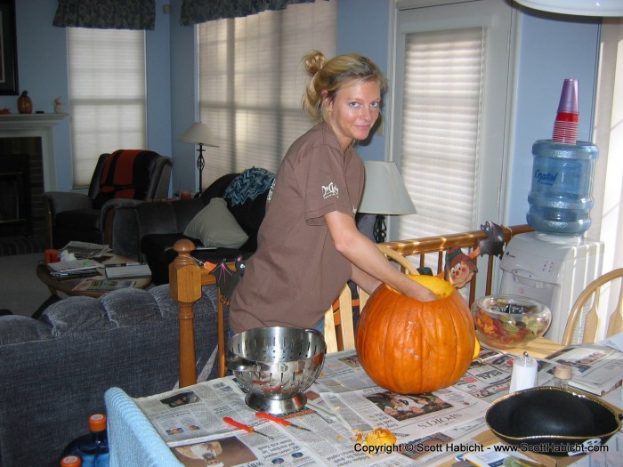 Kelli took the pumpkins, and begins carving....