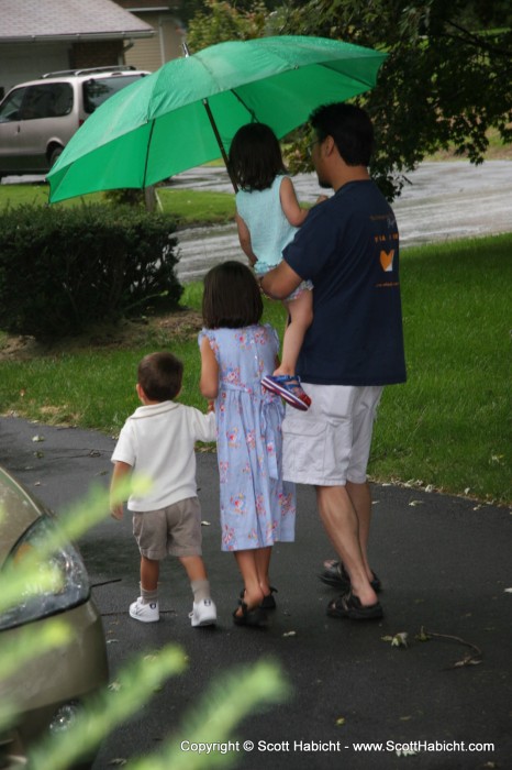 Pete being a swell guy and leading the kids out to the car in the rain.