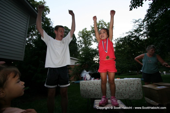 Ashley accepts her medal like a gymnast.