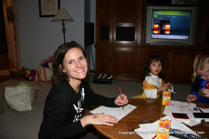 After trick or treating, the kids were inside having fun playing and drawing.