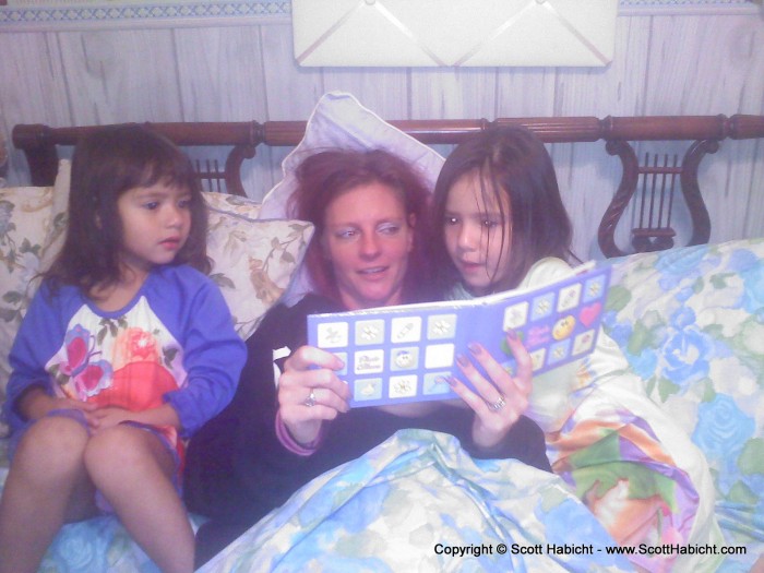 Kelli, playing the role of Aunt Kelli, and reading to the children one night.