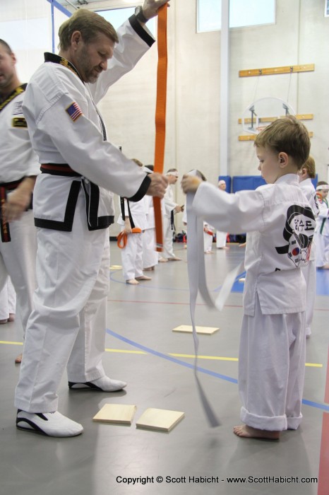 Proving his worth, the time had come to receive his orange belt.