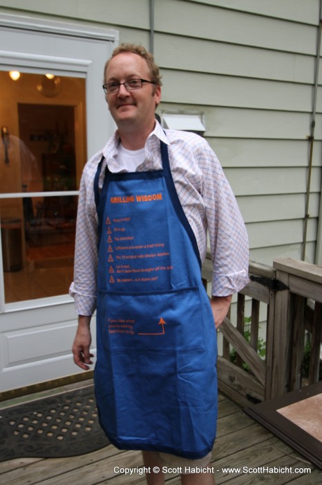 Showing off his new apron.