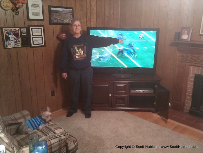 My mother-in-law shows how big her new TV is, and she loves it!!!