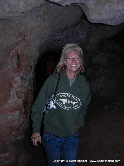 She is laughing because he took a million pictures in the cave.