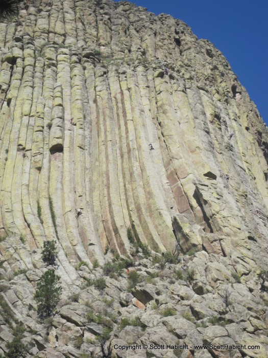 The rock structure with climbers on it.