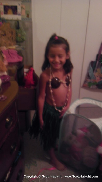 Sophia tries on the hula outfit we bought her in Hawaii.