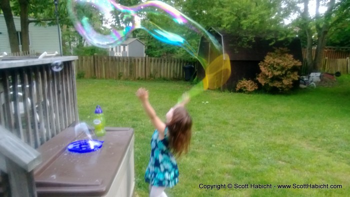 Jillian playing with some bubbles in her backyard.