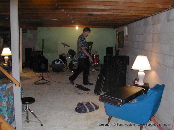 Scott Gray sets up his guitar rig in Ryan's basement.