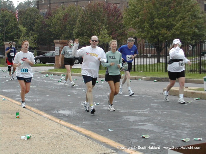 There's Kelli and Mike now. Mile 4 and looking good! (That's Brian Shadrick's work in the background)