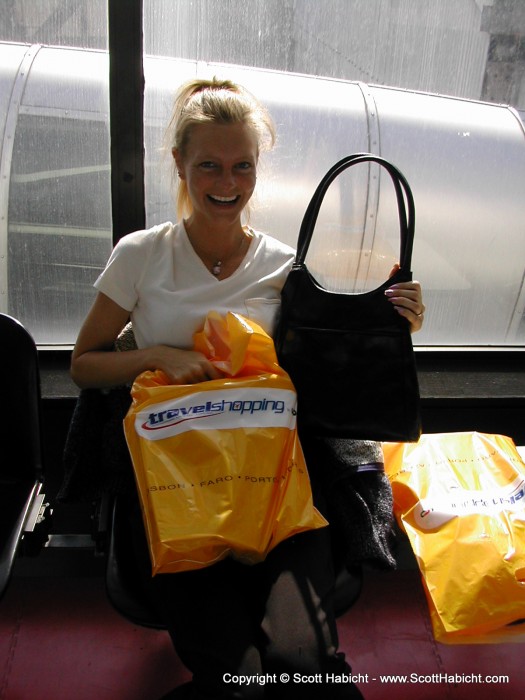 Kelli displaying some of the many treats from our trip while waiting in the airport.