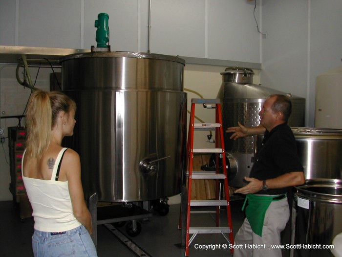 The manager tells us about the wine making process. The drum in the front is what they use to juice the fruits. The one in the back is for fermentation.