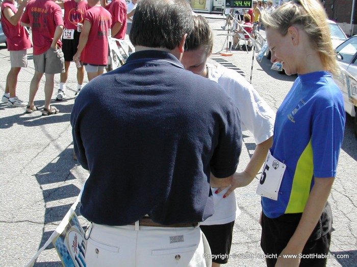 Kristi is almost thrown out for spilling beer on her shirt. Kidding, just getting her race number for the standings.