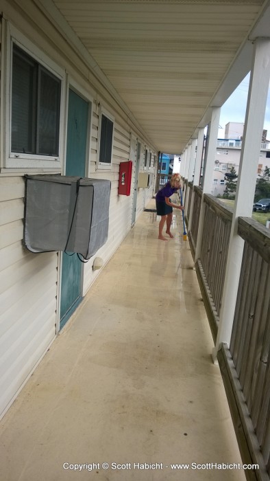 Kelli, fed up with the water on the balcony, decided to sweep it off.