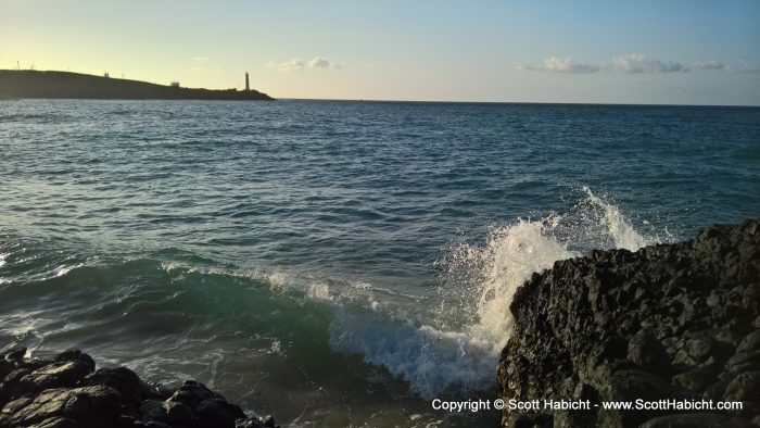 Waves crashing into lava rocks.