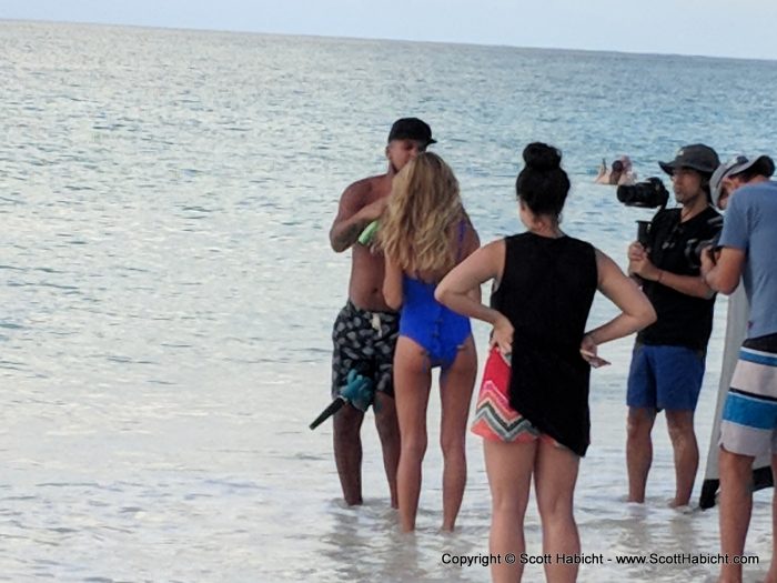 Notice how they clip the back of her bathing suit to make it fit.